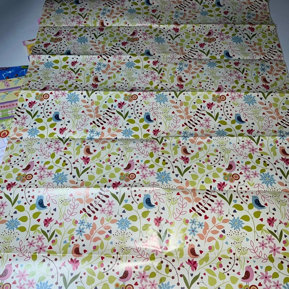 NWOT 15 sheets of flowered wrapping paper. Most sheets are 20” x 30”, at a min